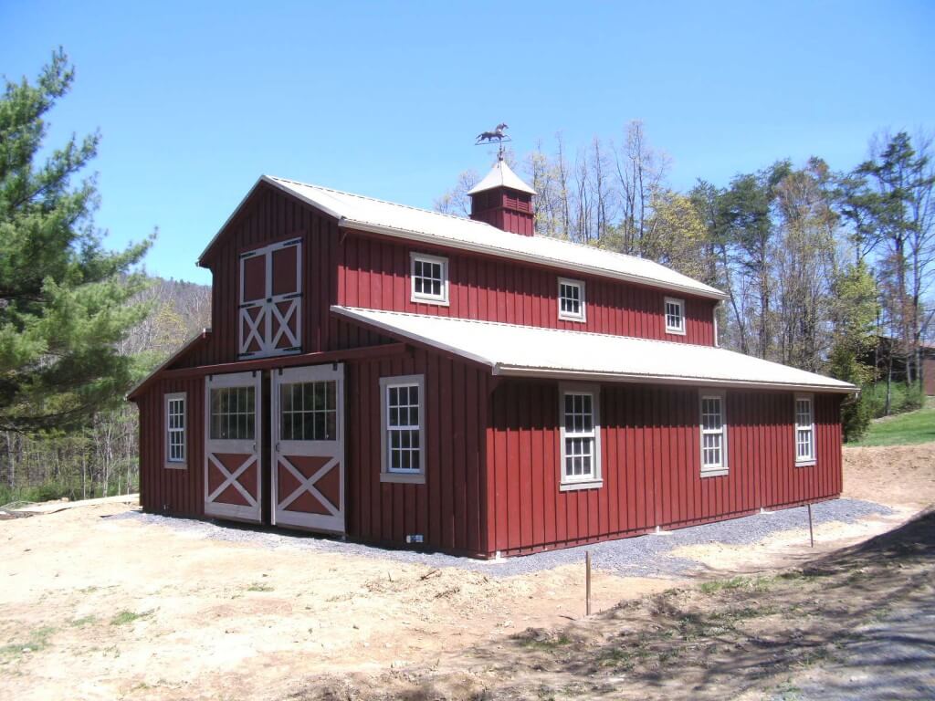 large red horse barn with white trim and roof