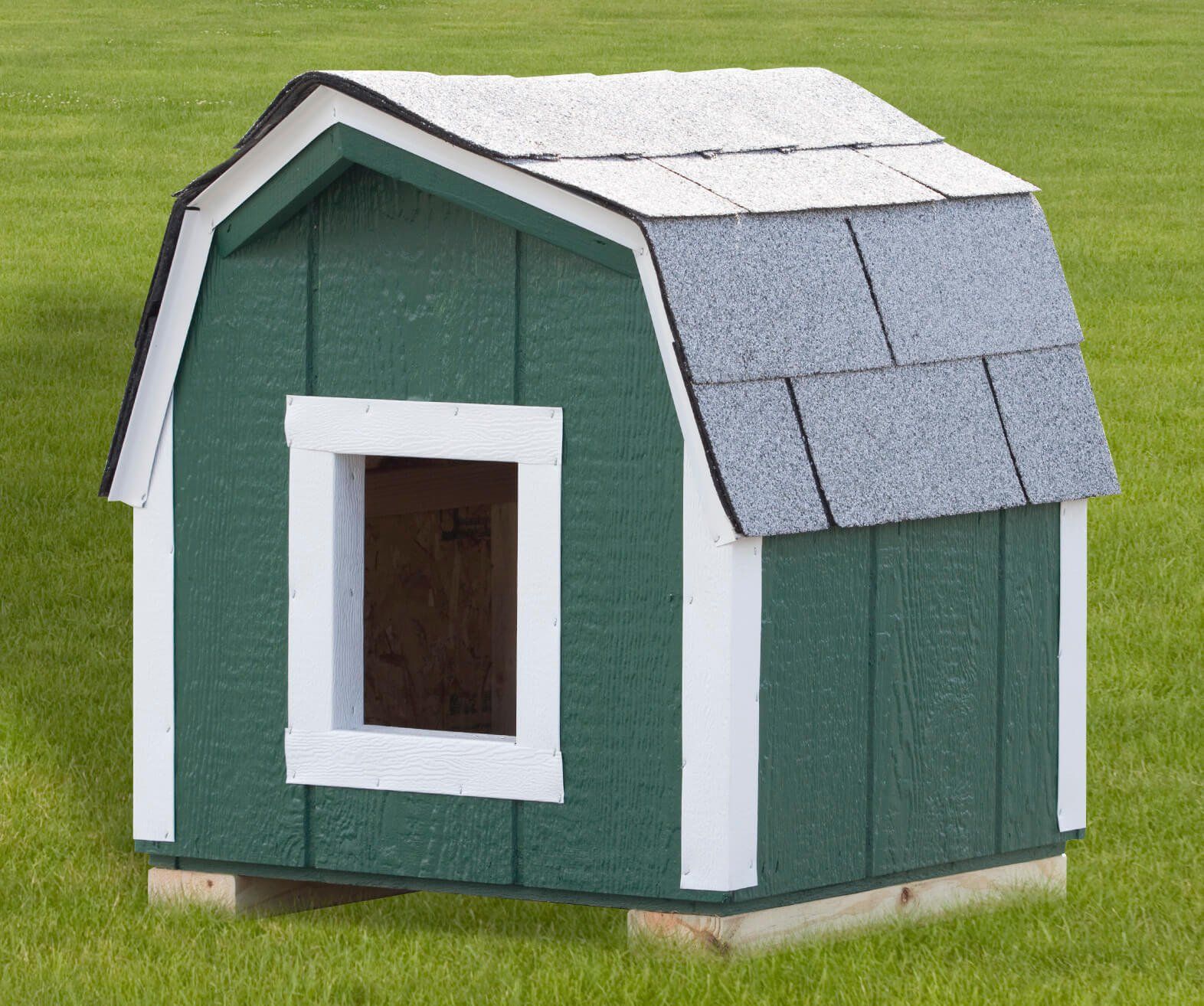 green dog house with white trim and grey roof