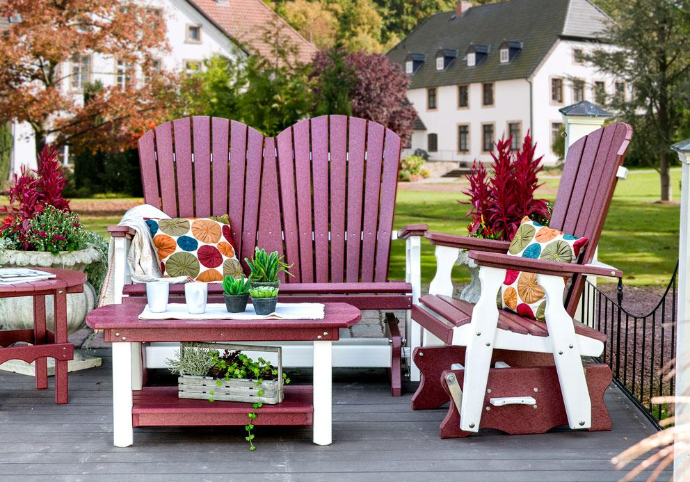 red and white poly furniture with pillows, plants, and drinks