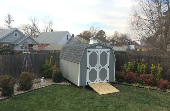 grey mini barn with ramp and white door