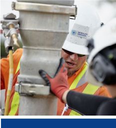 Two employees perform hydro excavation