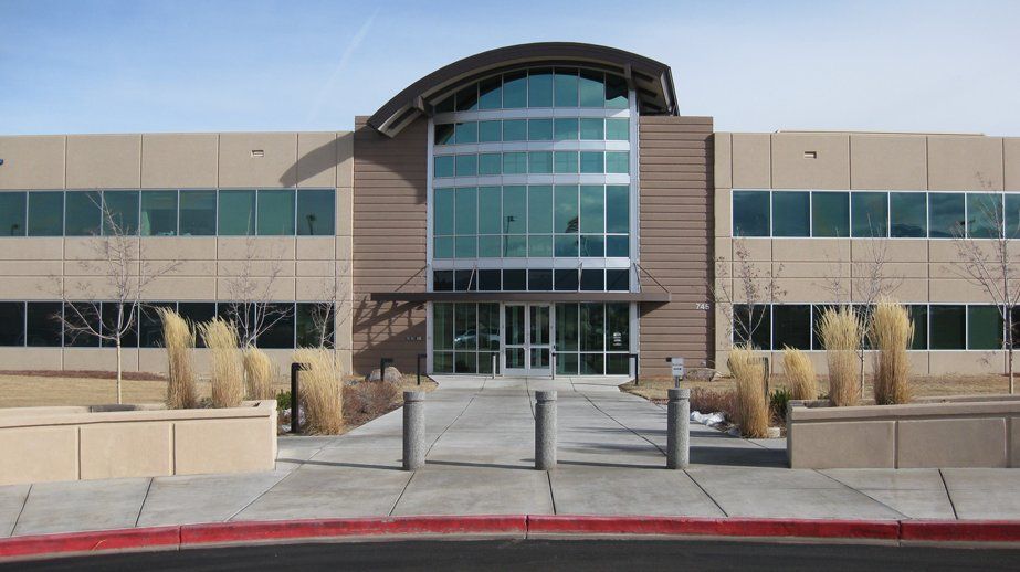 A large building with a lot of windows and a red curb