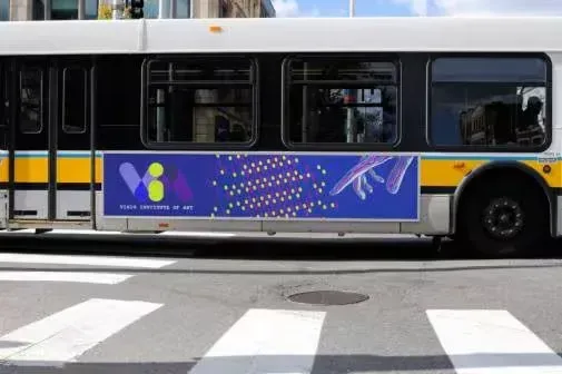 A bus with a purple sign on the side is driving down a street.