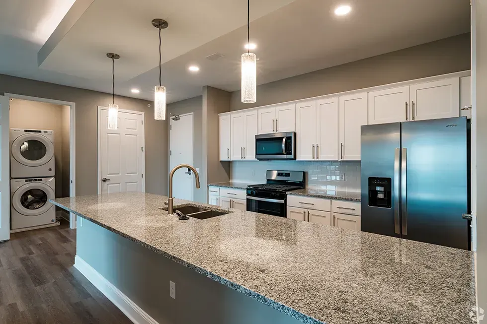 A kitchen with granite counter tops and stainless steel appliances