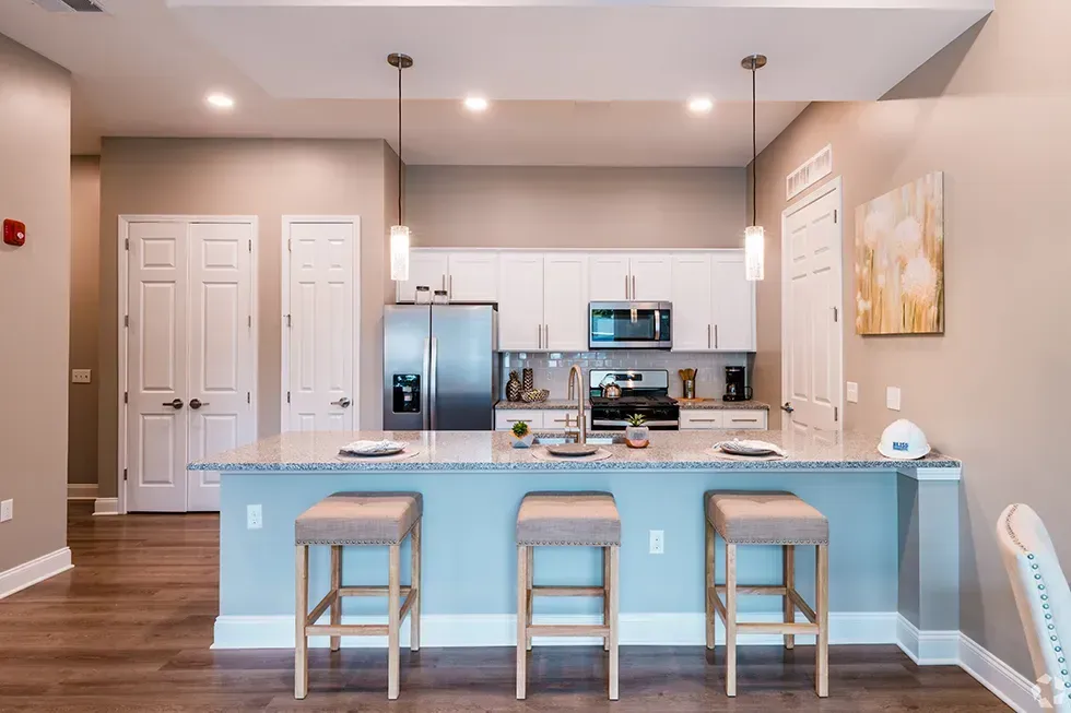 A kitchen with a large island and stools