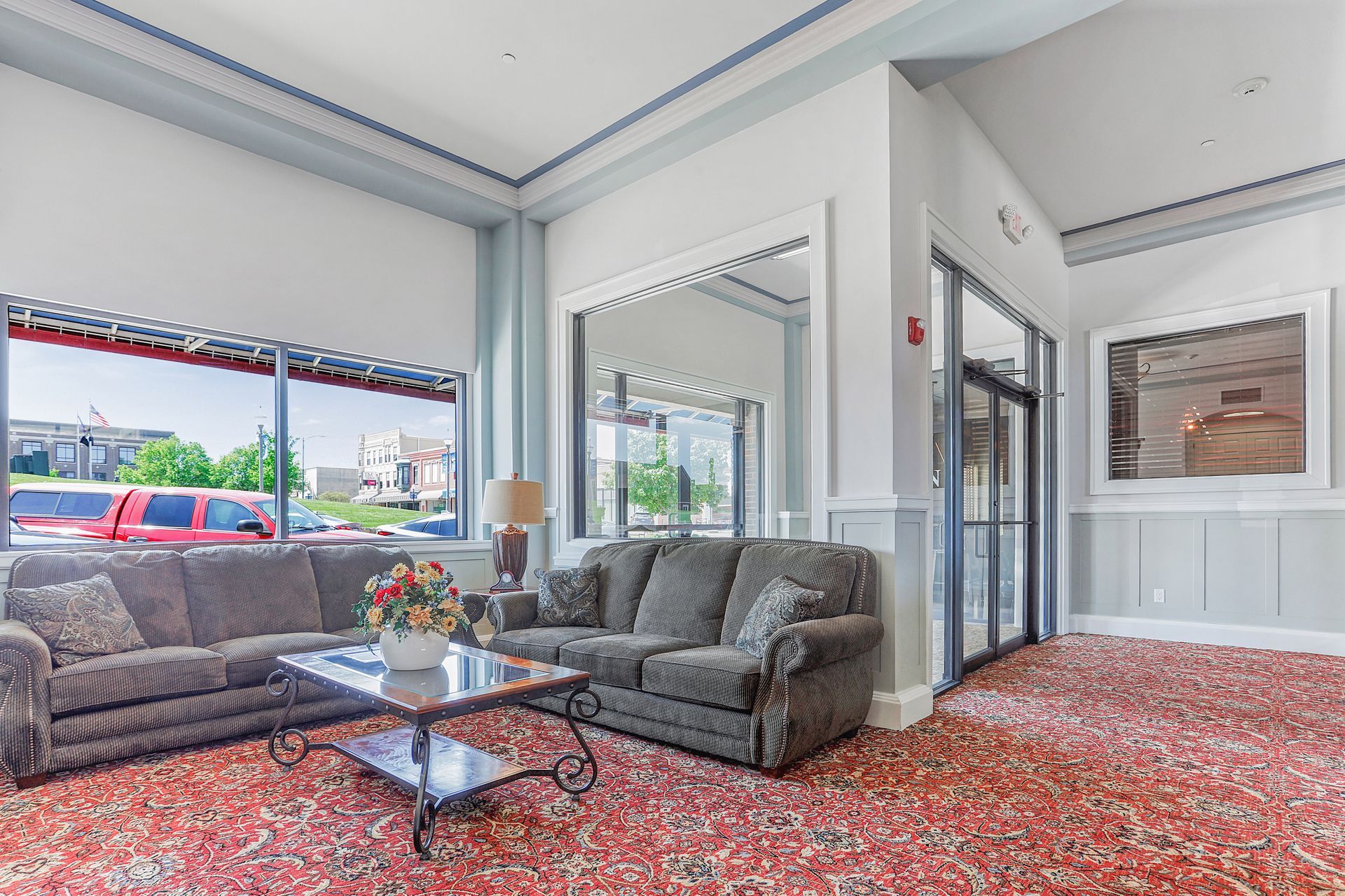 A living room with a couch and a coffee table in a hotel lobby.