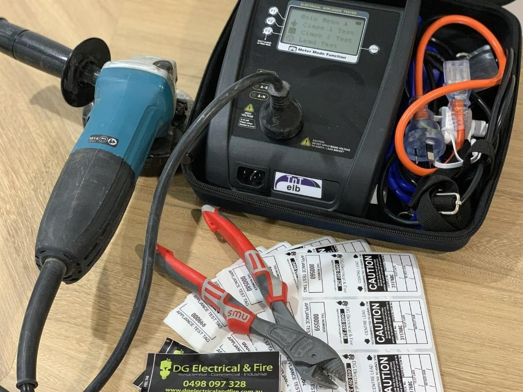 A Makita Grinder Is Sitting On A Table Next To A Tester And Pliers — DG Electrical & Fire In Kiama, NSW