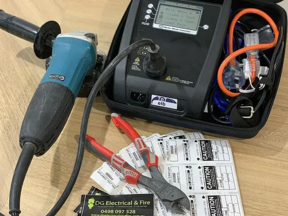 An Electrician Is Using A Multimeter To Test A Circuit Board — DG Electrical & Fire In Kiama, NSW