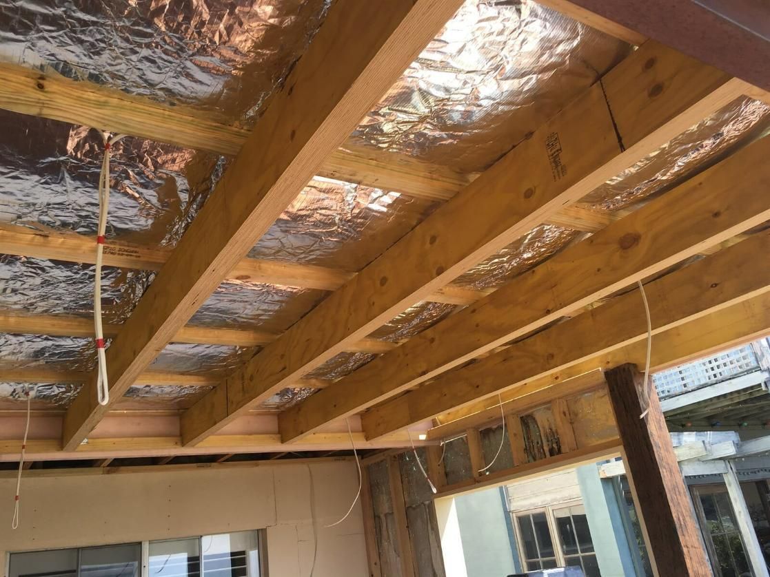 A Wooden Ceiling With Aluminum Foil On It — DG Electrical & Fire In Kiama, NSW