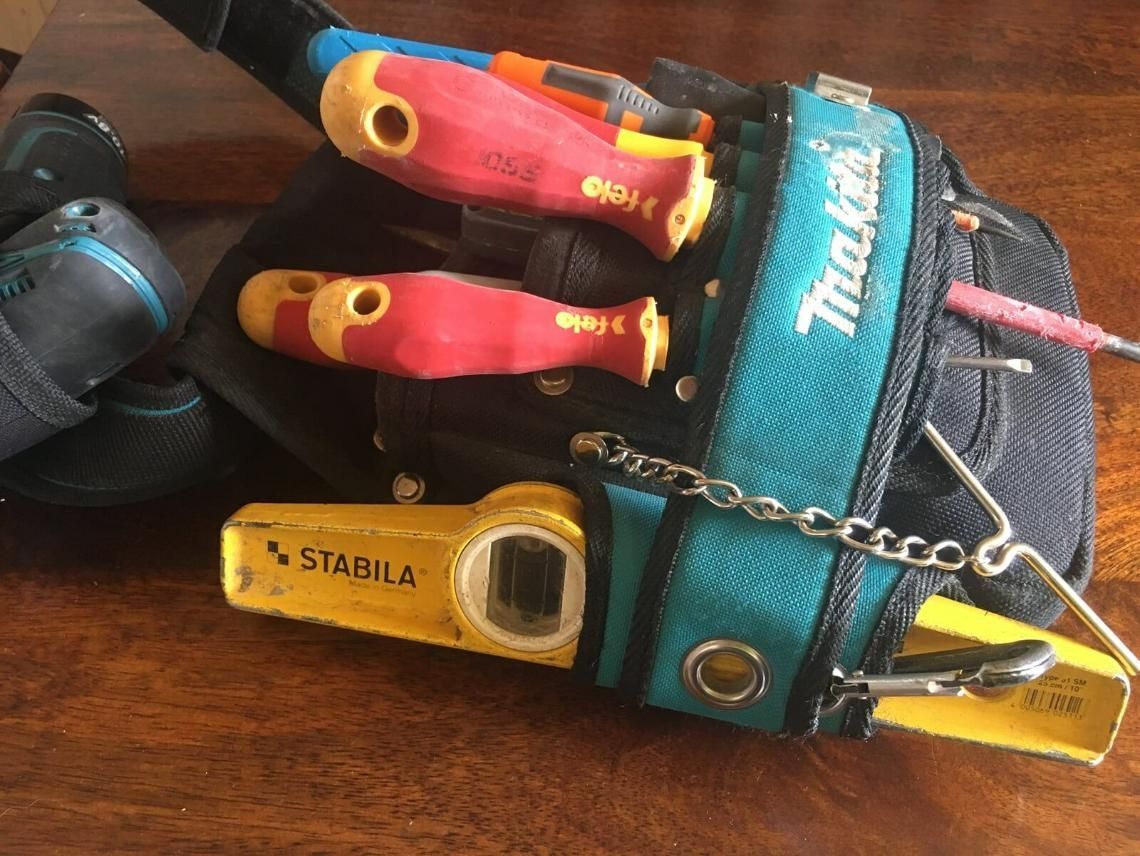 A Makita Tool Bag Filled With Tools On A Wooden Table — DG Electrical & Fire In Kiama, NSW