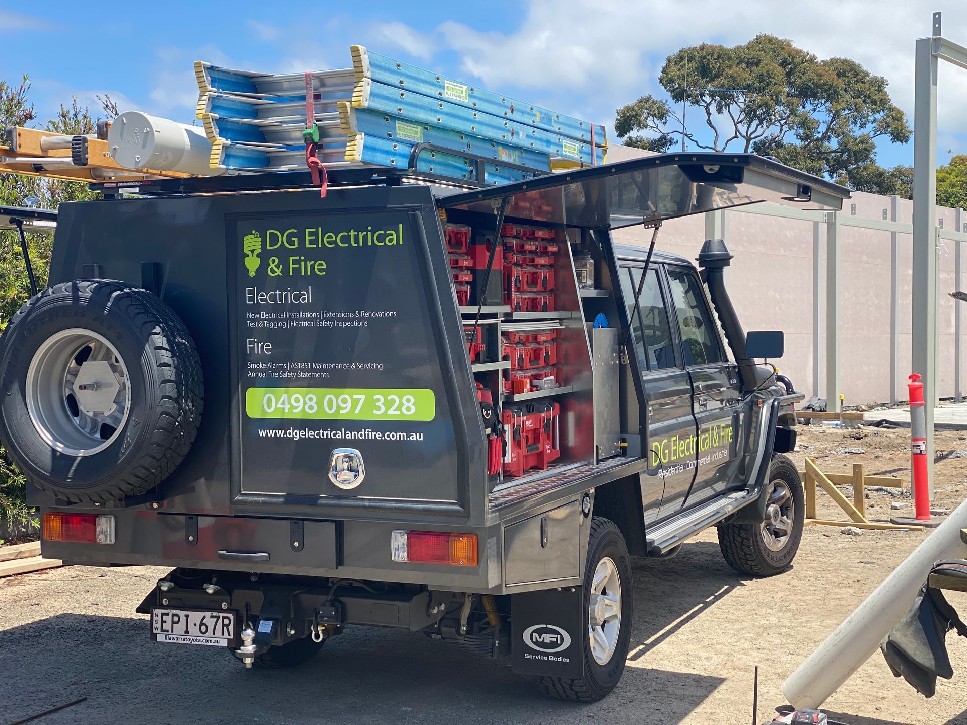 A Black Truck Is Parked In Front Of A House — DG Electrical & Fire In Kiama, NSW