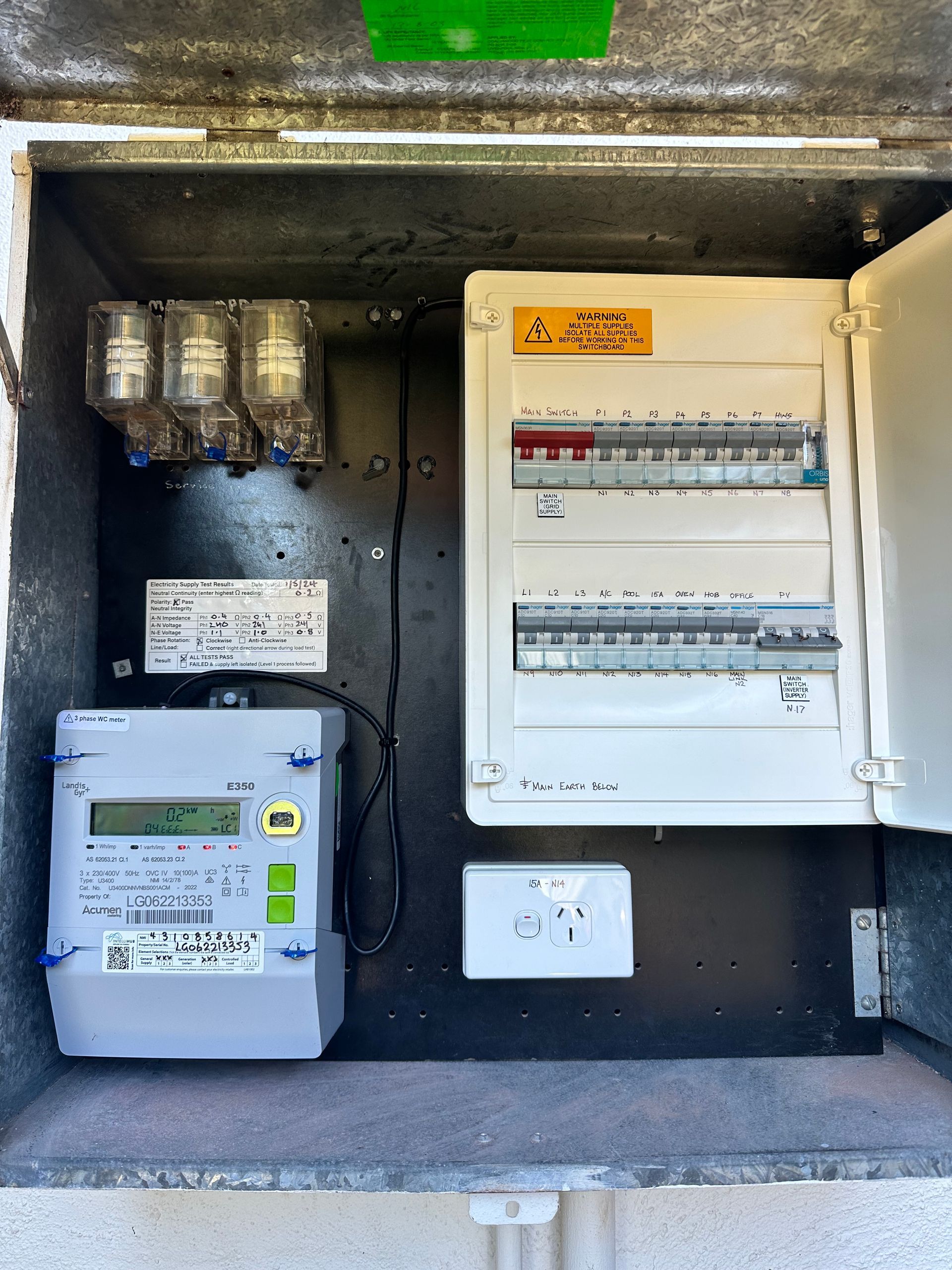 Electric meter and circuit breaker box with various switches, wires, and a power outlet. — DG Electrical & Fire In Kiama, NSW