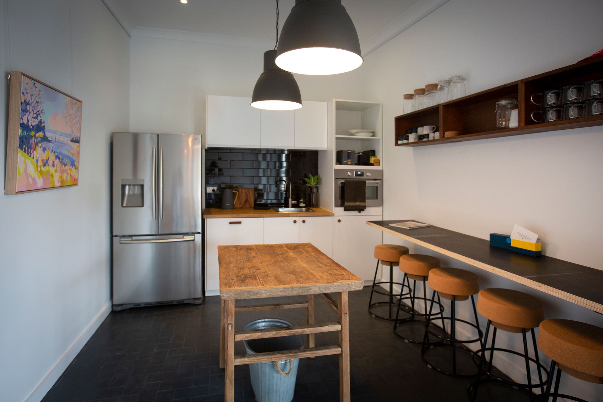 Kitchen With Stainless Steel Fridge, Island, Black Countertop — DG Electrical & Fire In Kiama, NSW