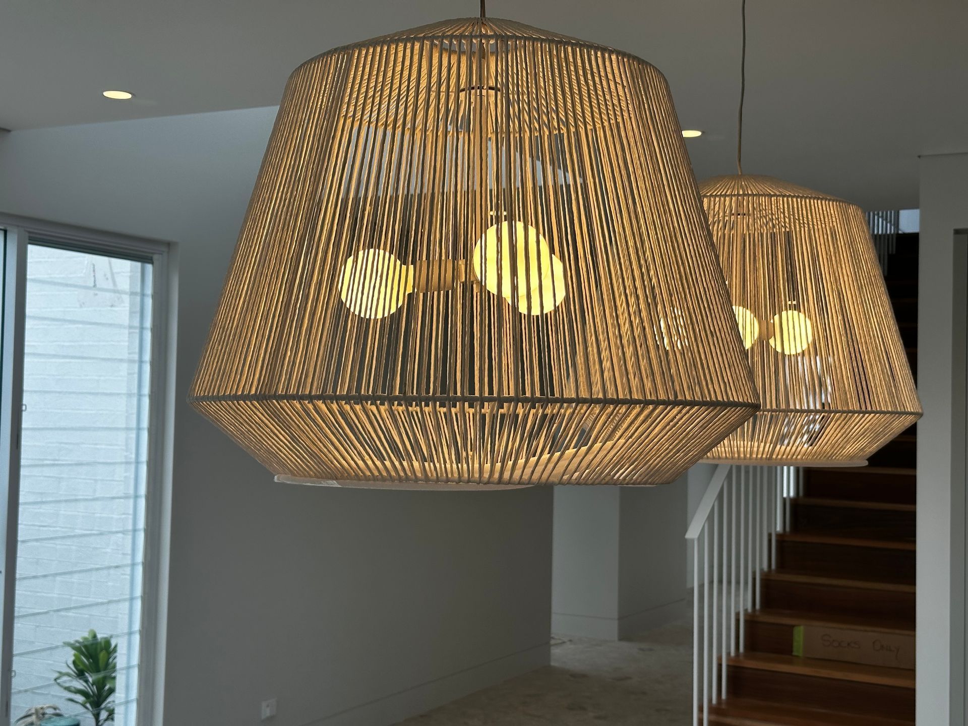 Two Beige Woven Pendant Lights Hanging Above a Stairwell — DG Electrical & Fire In Kiama, NSW