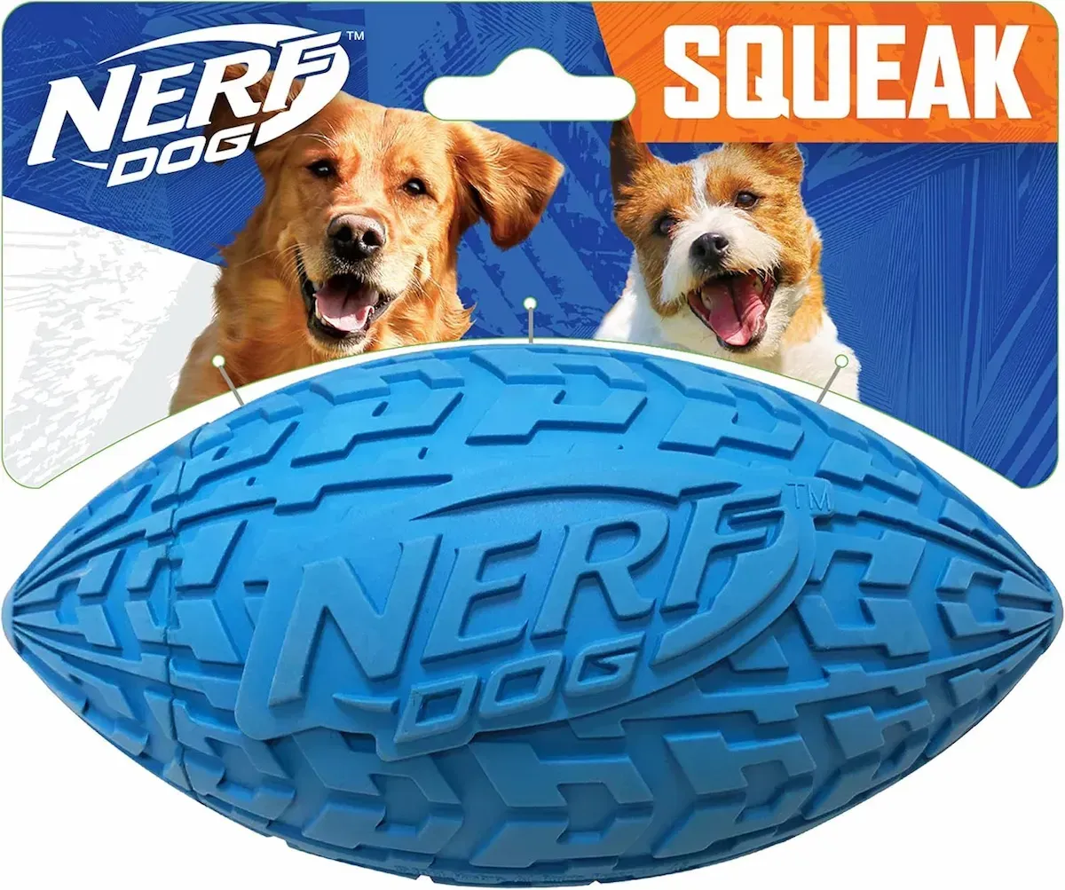 Two dogs are playing with a blue nerf dog squeak football.