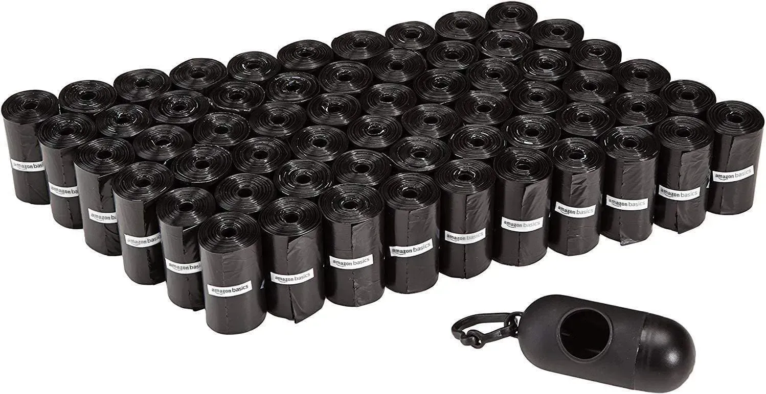A bunch of black bags and a black bag dispenser on a white background.