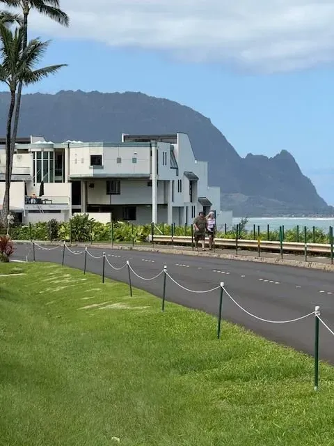A man in a plaid shirt is using a laptop