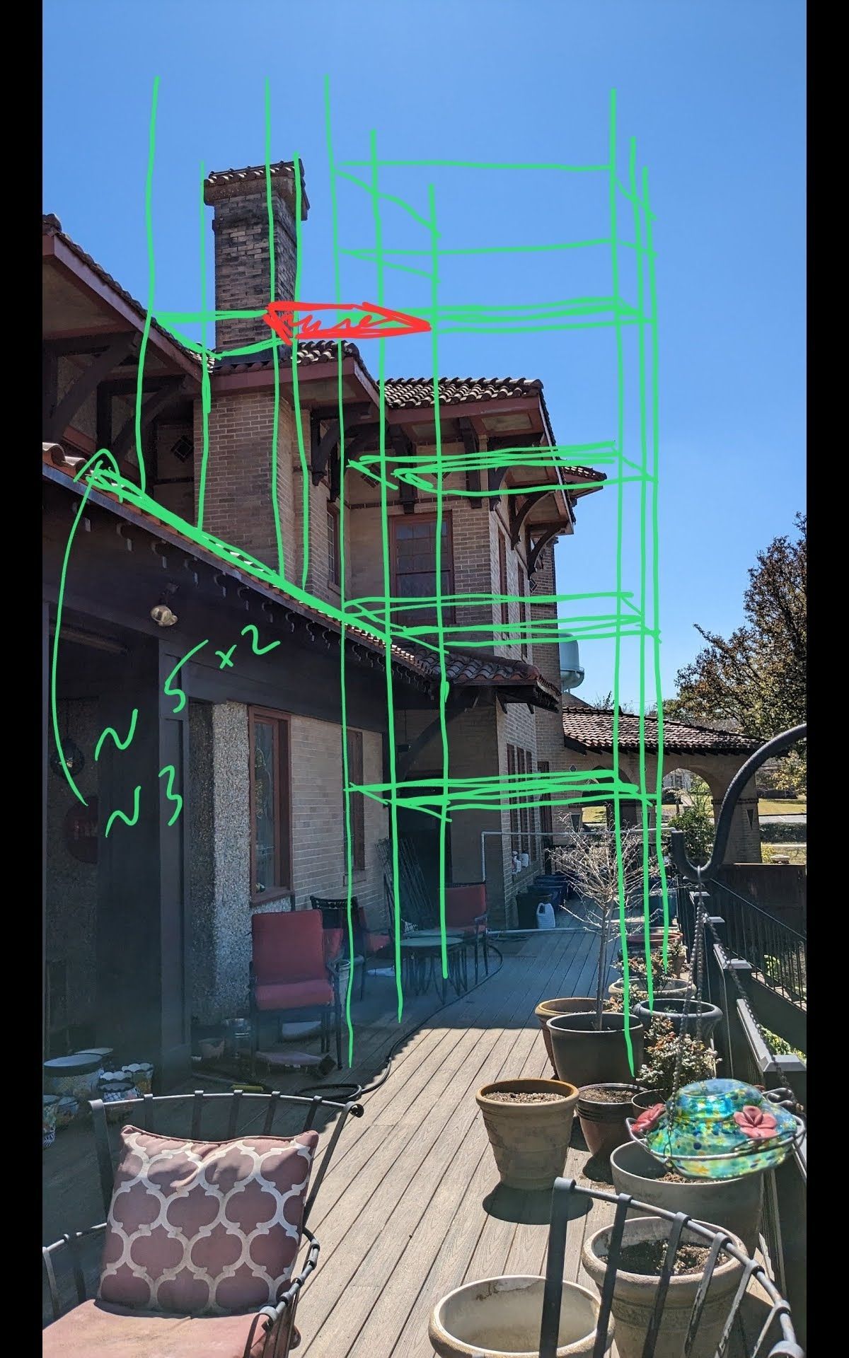 A house with a lot of potted plants on the deck.