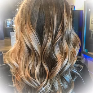 Wavy, highlighted hair with shades of blonde, brown, and gold.