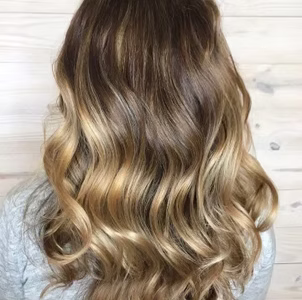 Wavy brown and blonde ombre hair.