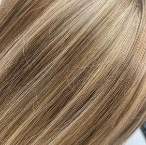 Close-up of straight, layered blonde hair with highlights.