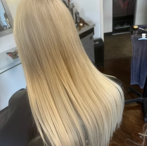 Blonde hair, straight and long, styled at a salon.