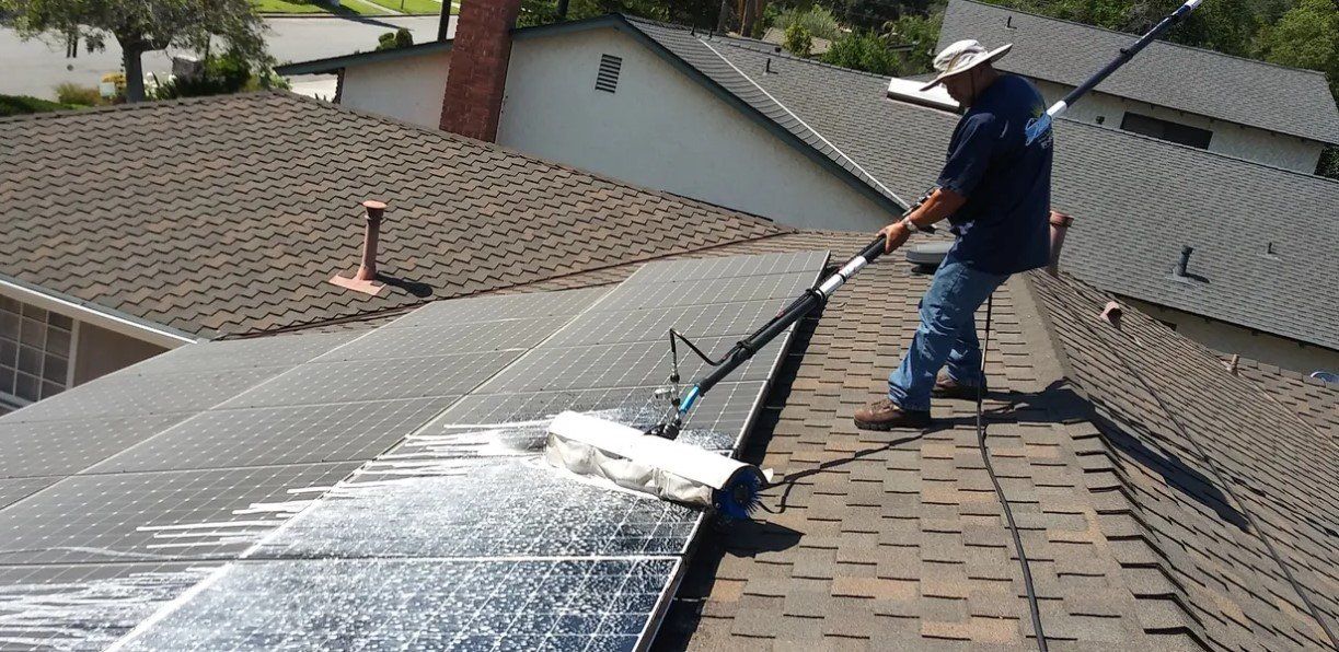 Man Cleaning Solar Energy Panel