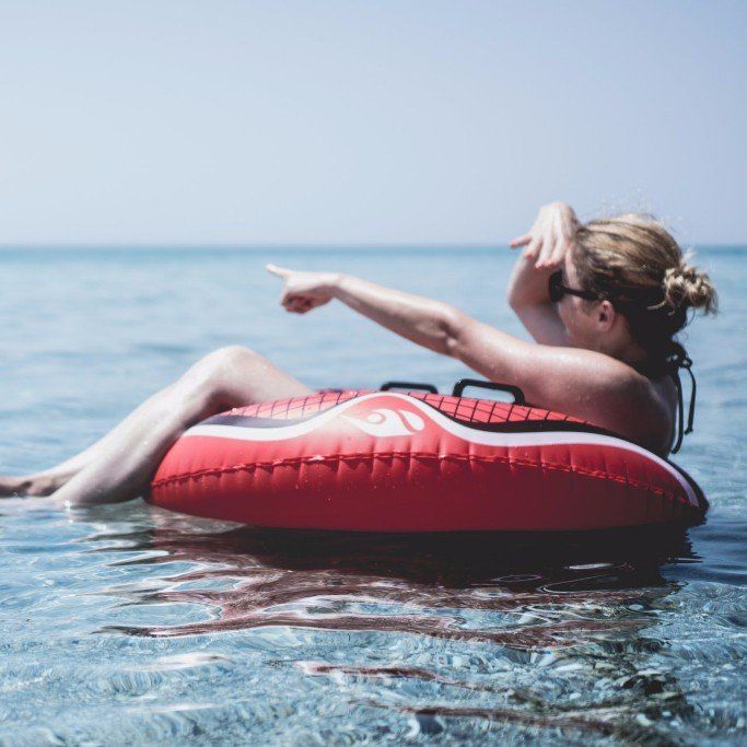 Woman floating on an inner tube