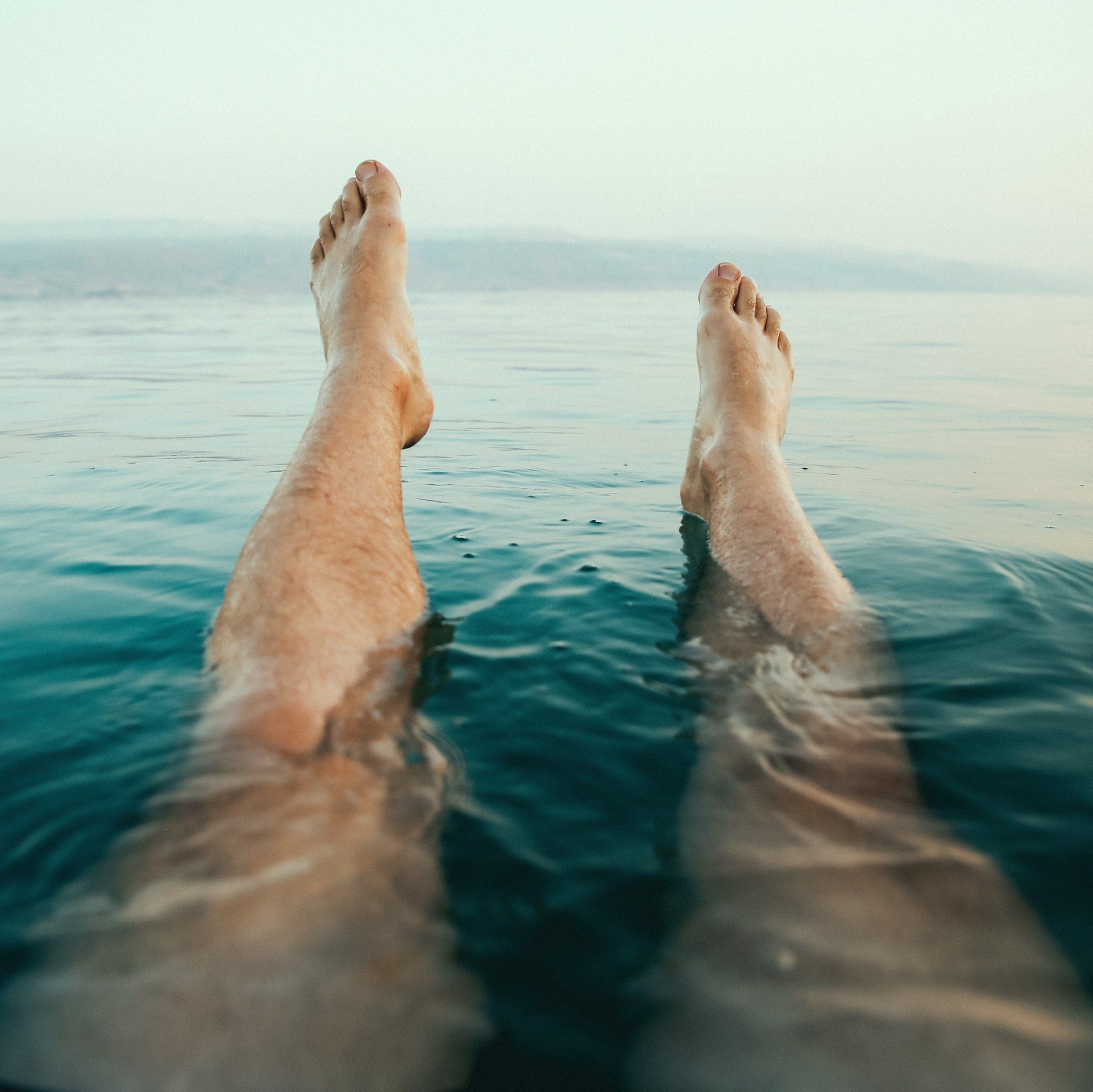 Point of view image of a swimmer looking down at their legs