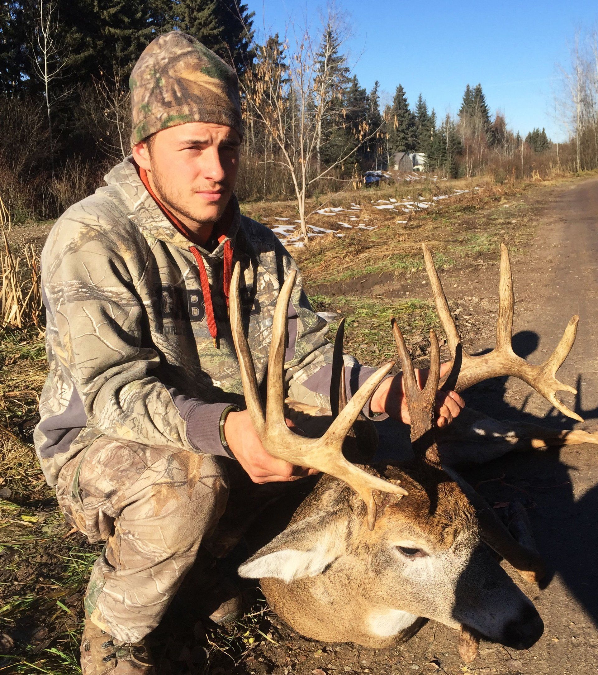 Hunter with dead deer