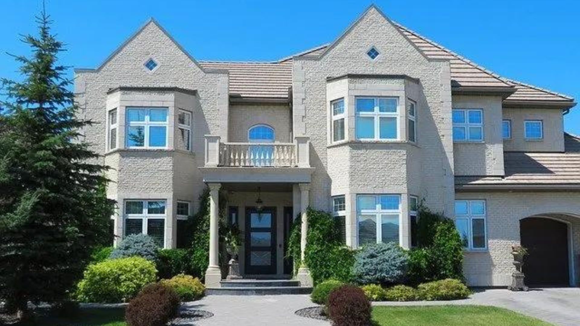 a large house with a lot of windows and trees in front of it