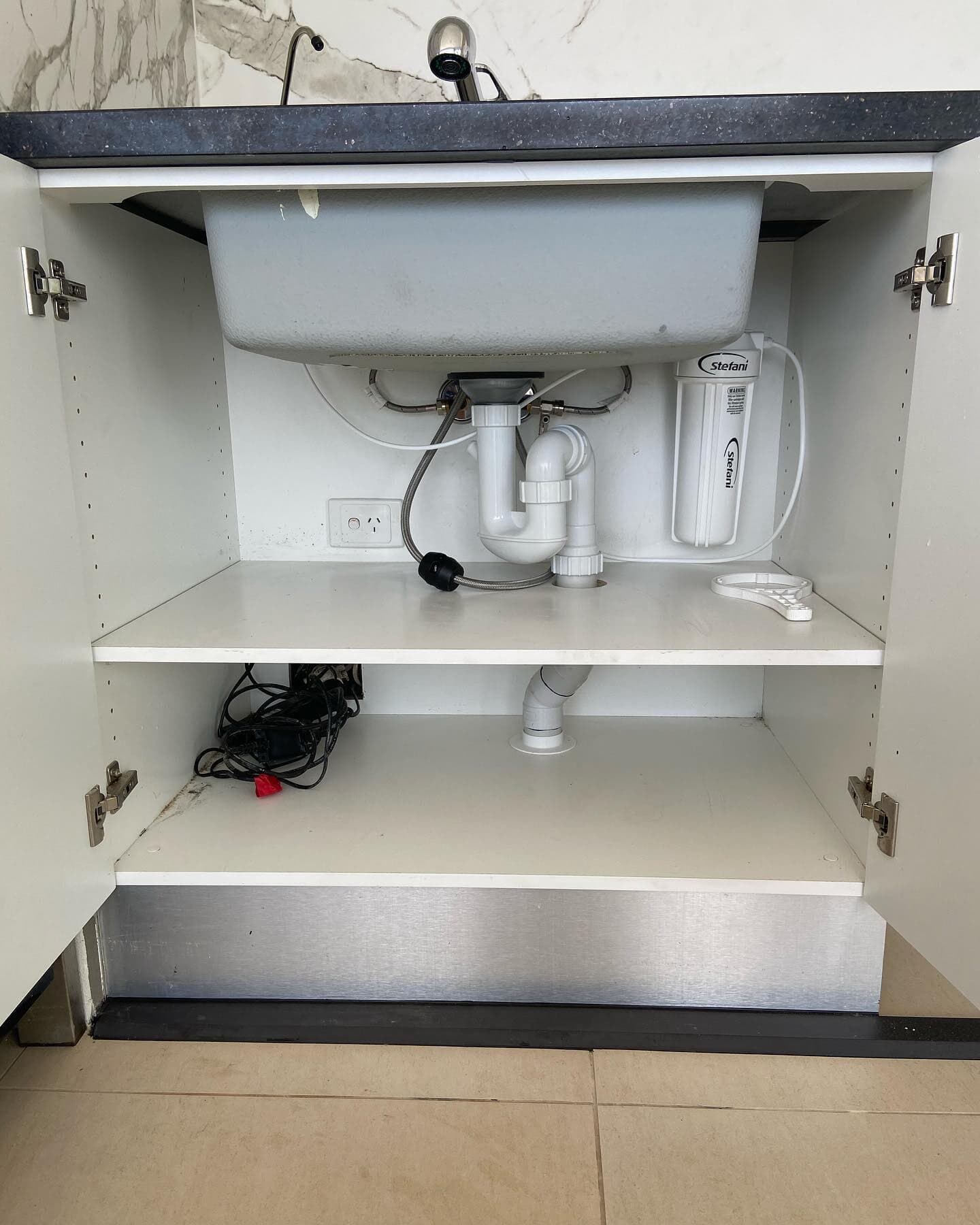 Inspecting Pipes Under the Kitchen Sink — Rossi Plumbing in Gold Coast, QLD