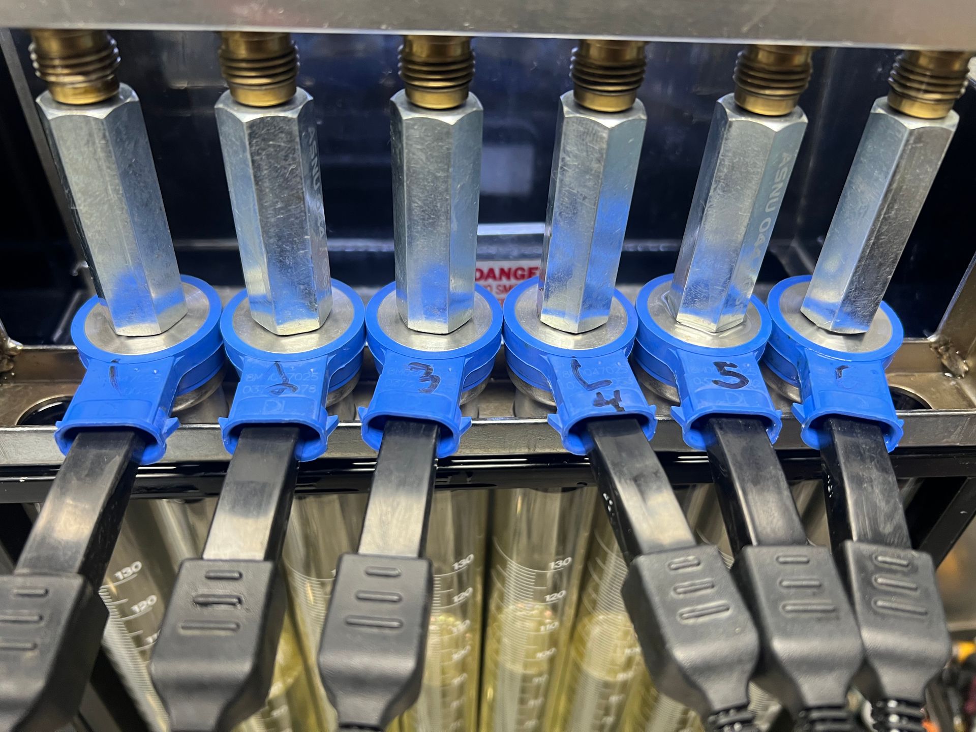 Close-up of six connected electrical terminals, each labeled 1 through 6, in a metal housing.