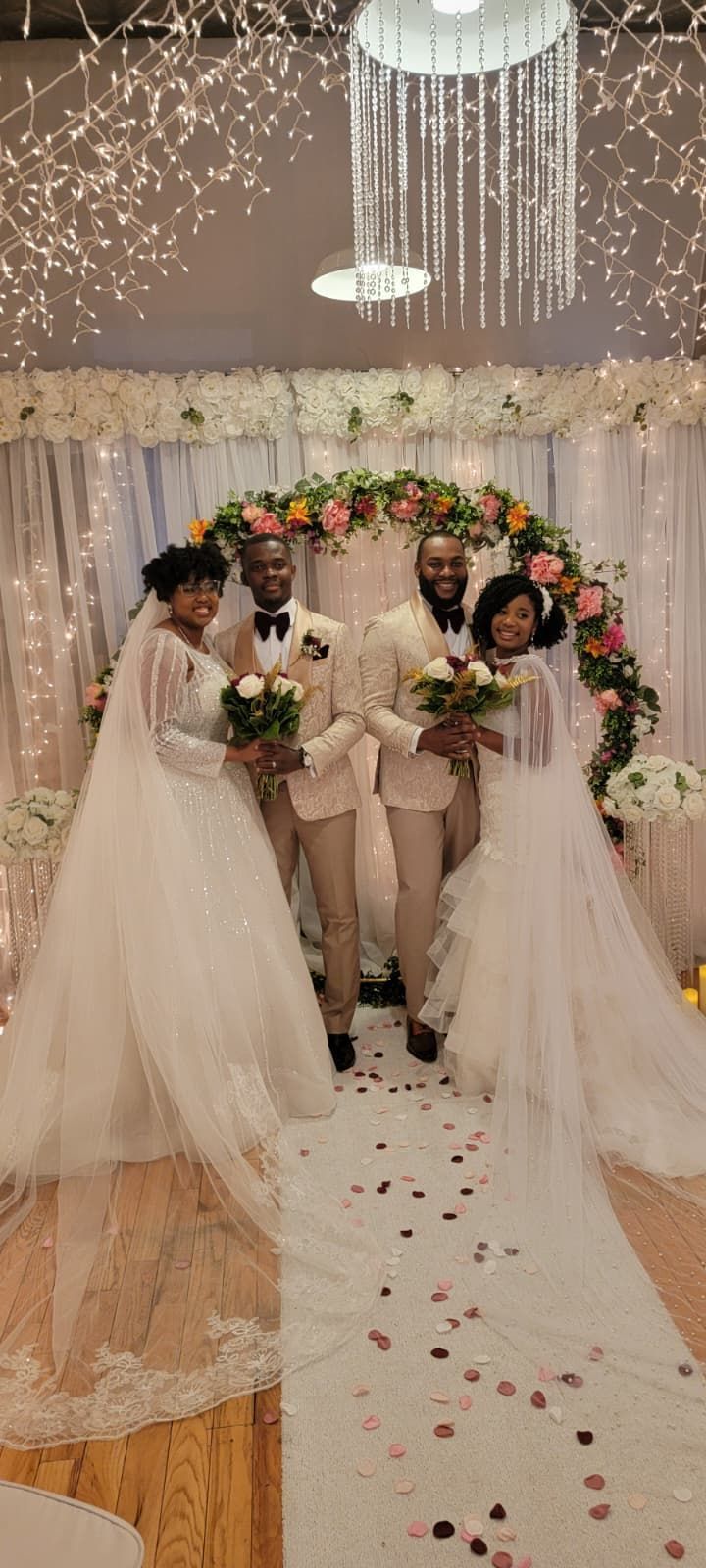 Couple exchanging vows during outdoor wedding ceremony; officiant reads from a binder.
