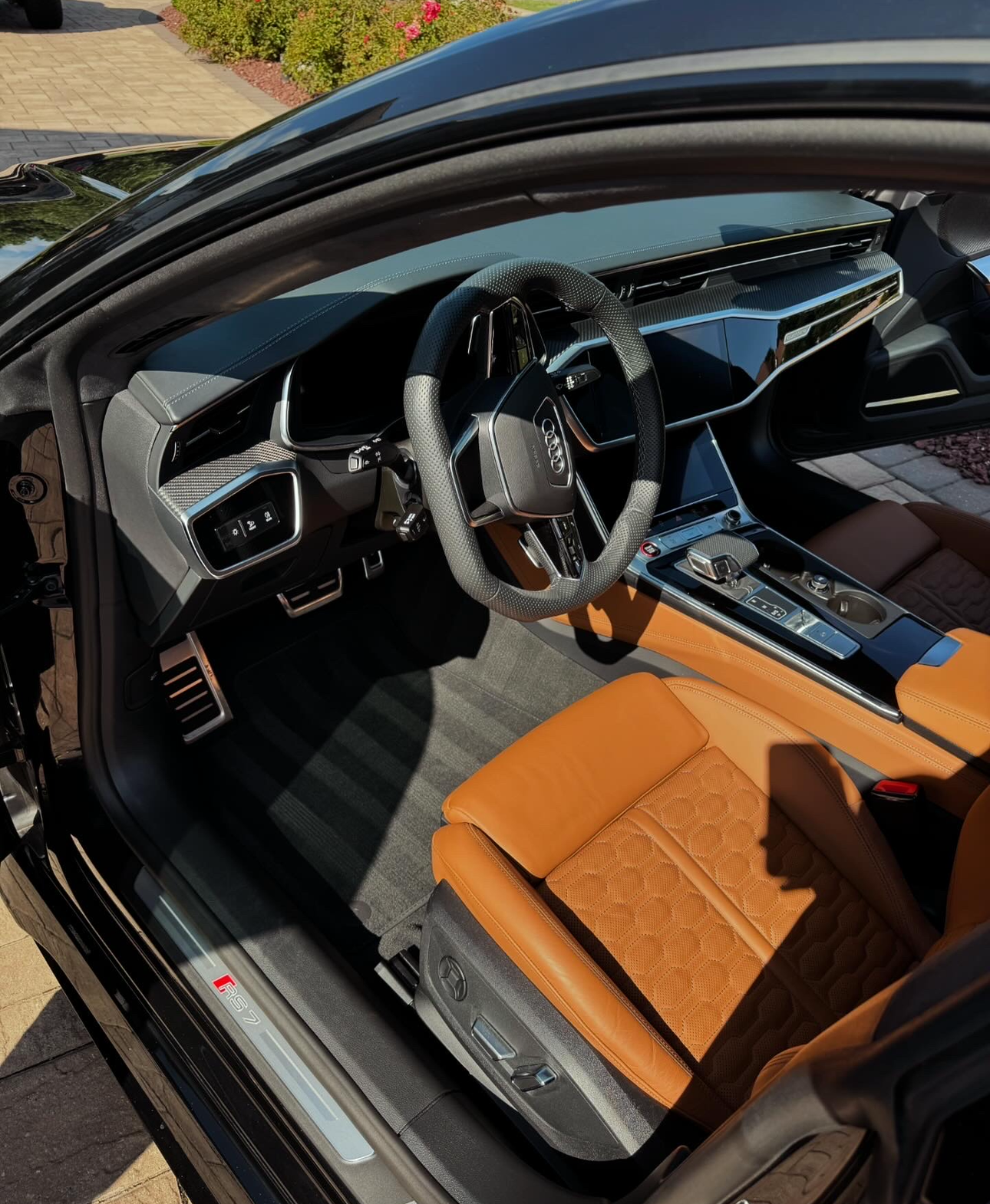 A black car with brown seats and a steering wheel