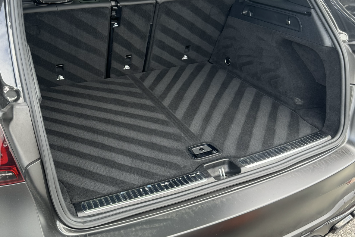 The trunk of a black car with a striped pattern on it.
