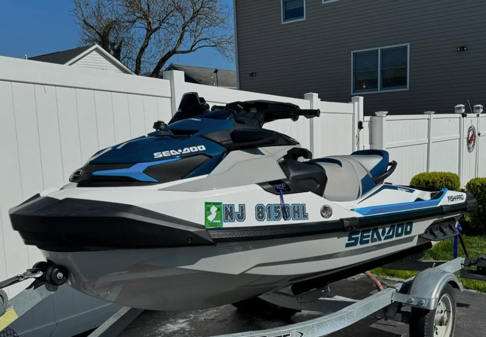 A sea doo jet ski is parked on a trailer.