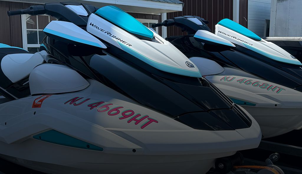 A row of jet skis are parked in front of a building.