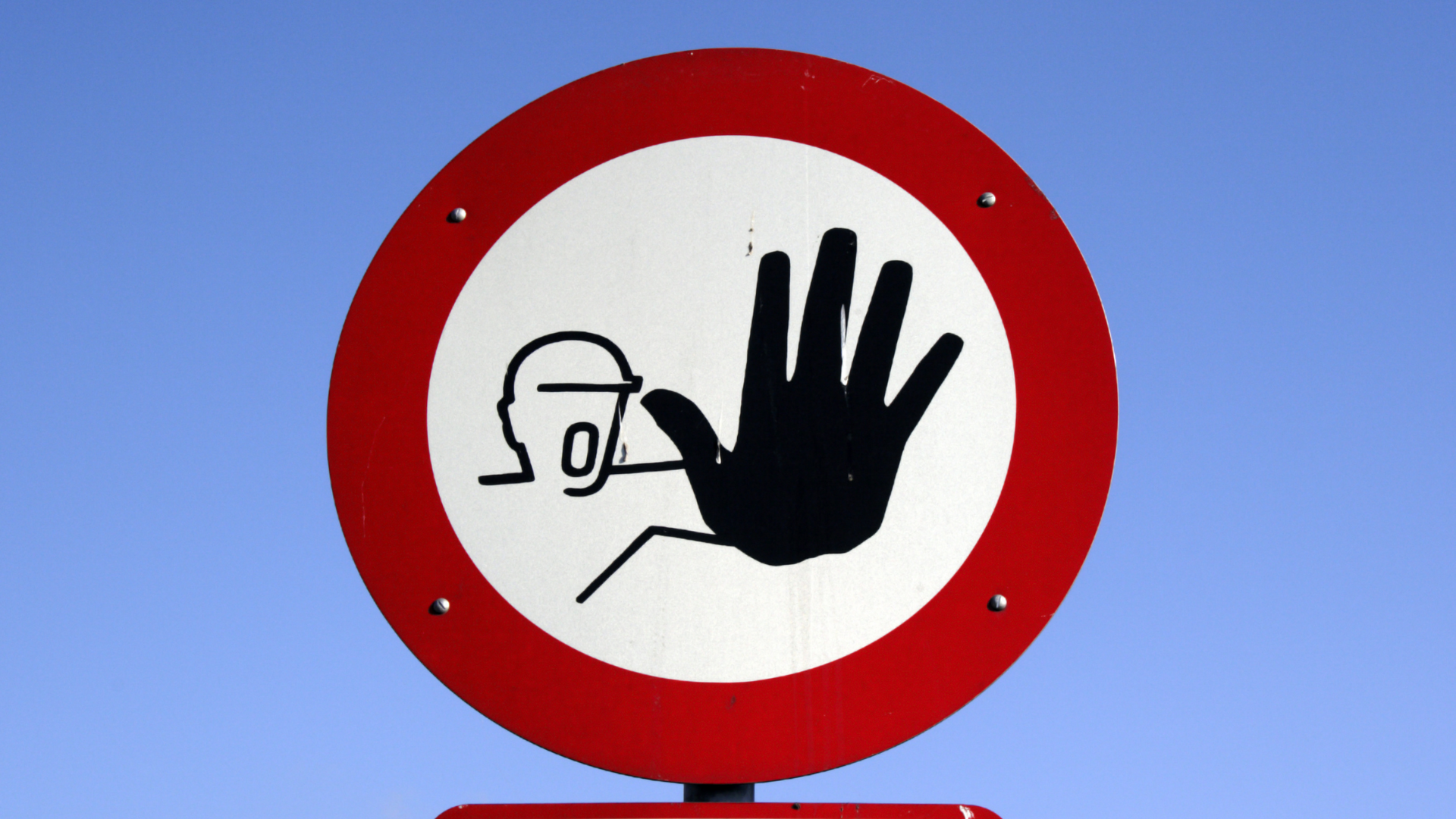 Red and white circular sign: hand blocking a person, indicating do not enter.