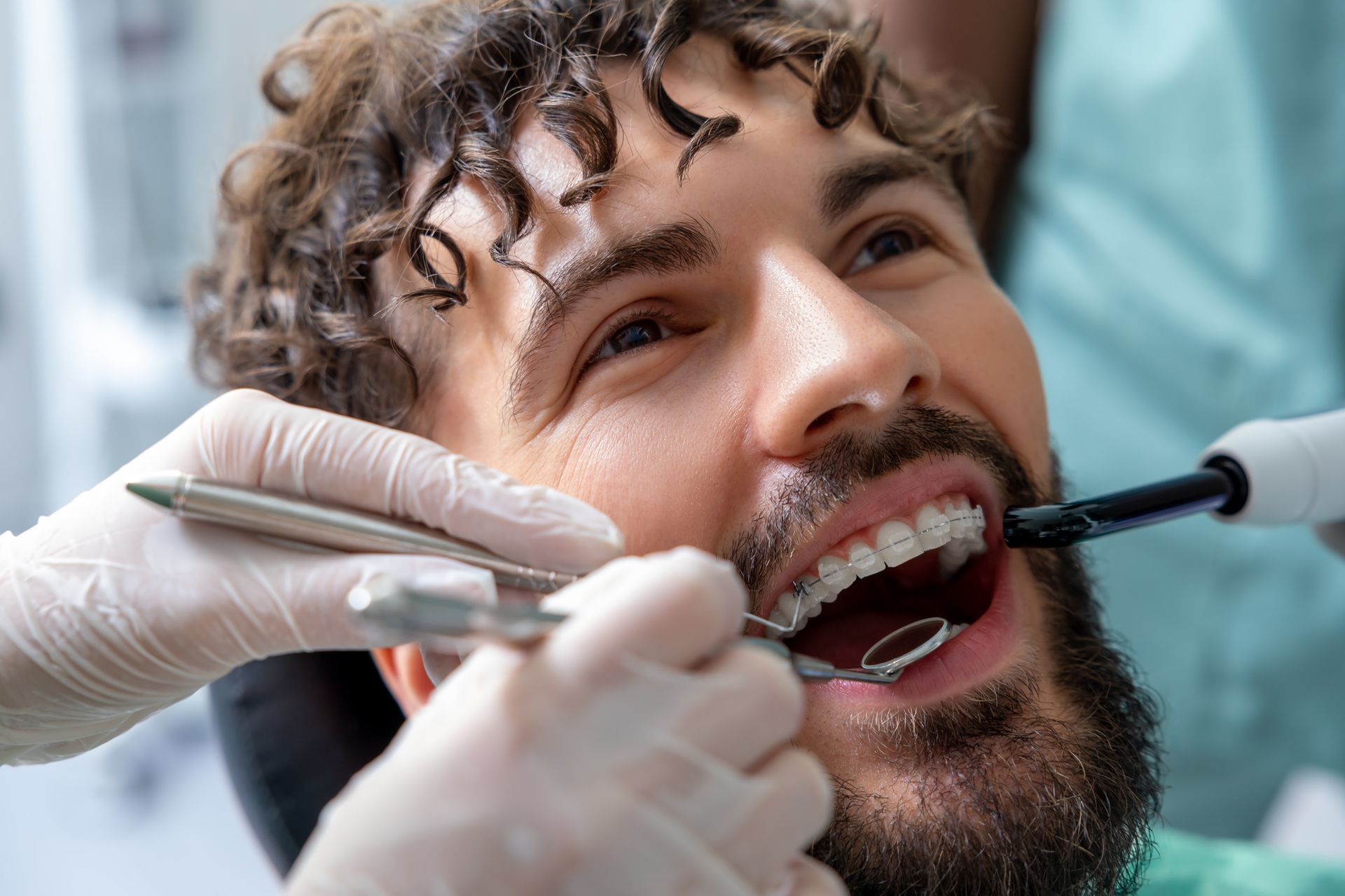A man is getting his teeth examined by a dentist.