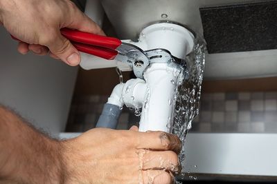 Fixing Sink Pipe With Adjustable Wrench — Spring Valley, CA — Infinity Plumbing & Construction Inc.
