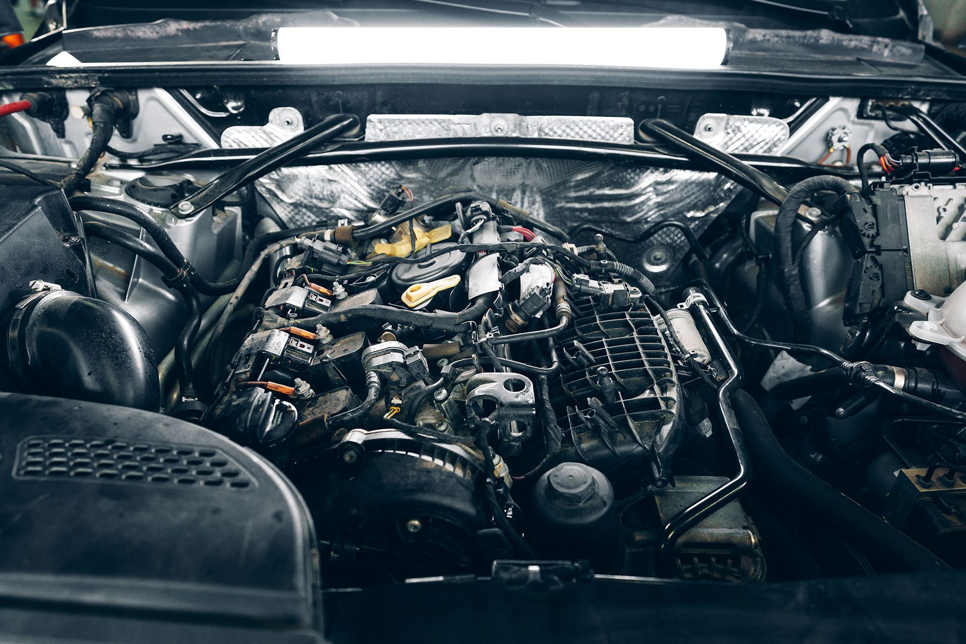 A row of white vans parked next to each other in a parking lot.