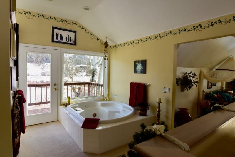 A bathroom with a jacuzzi tub and a balcony