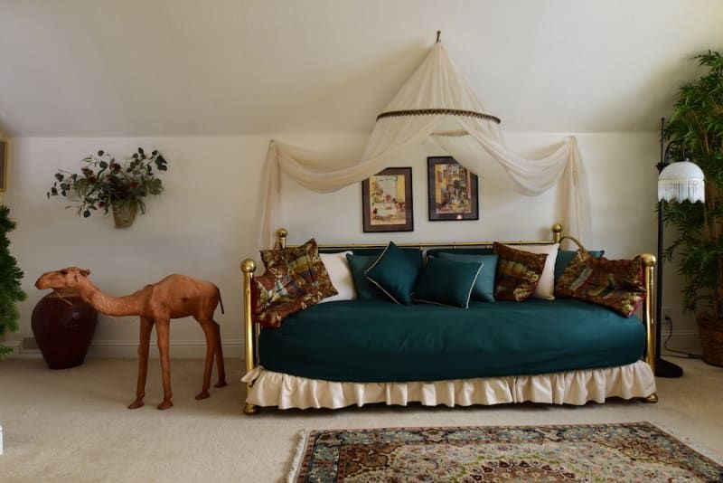 A living room with a couch and a camel statue