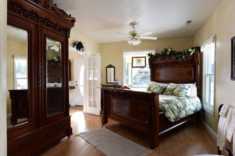 A bedroom with a king size bed and a wardrobe