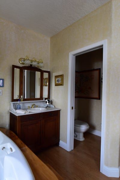 A bathroom with a sink a mirror and a toilet