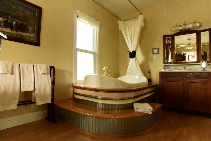 A bathroom with a jacuzzi tub in the middle of the room