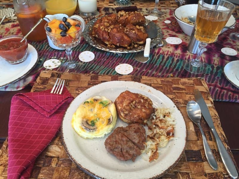 A table topped with plates of food and drinks.