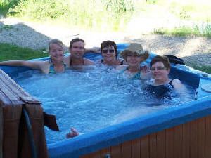 A group of women are sitting in a hot tub.