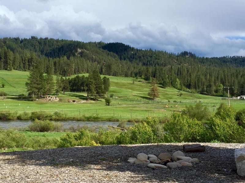A view of a golf course with mountains in the background